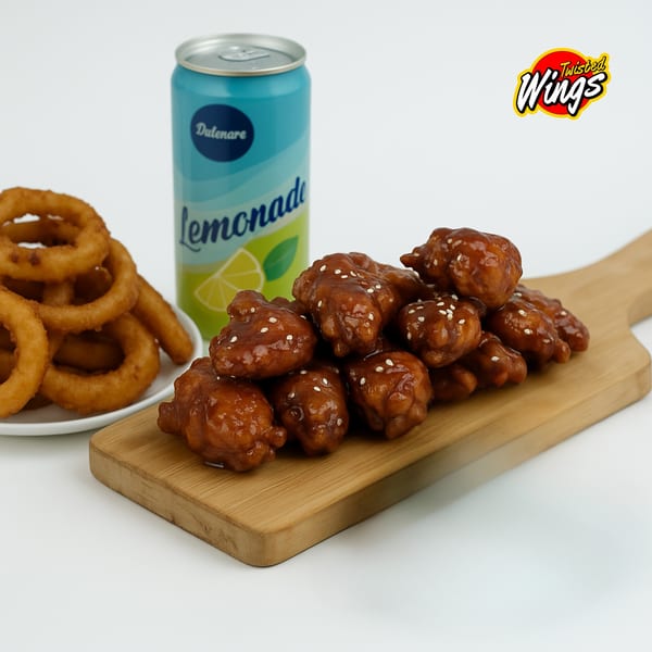 Twisted Wings boneless wings with sesame seeds, onion rings, and a can of lemonade.