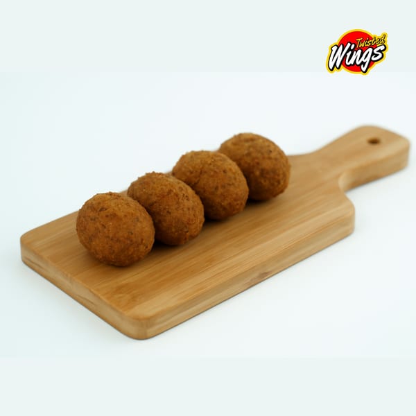 Four crispy, golden-brown Twisted Wings croquettes lined up on a wooden cutting board.